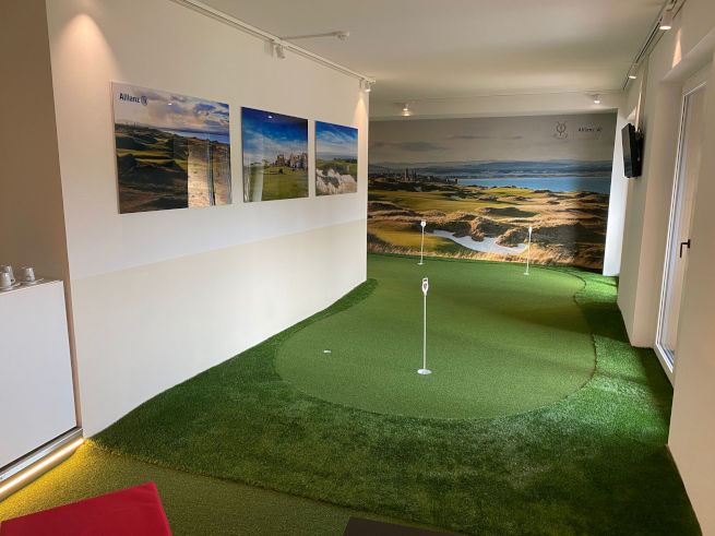 Metro New York indoor putting green in an office with scenic wall art